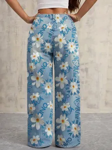 Detailed back view of wide-leg denim jeans featuring white daisy and text prints