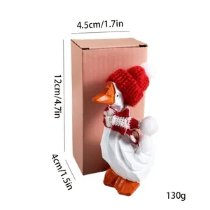 Figurine de canard blanc en bois avec chapeau de Noël et écharpe, détail hauteur 12cm