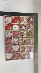 Detailed view of six sets of red and white wooden Christmas ornaments in wooden gift boxes