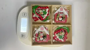 Weight display of boxed Christmas wooden hanging ornaments on a scale, 71.8g total