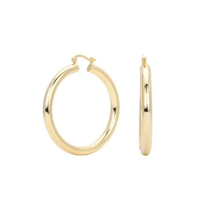 Detailed macro view of S925 sterling silver gold-plated large hollow hoop earrings.
