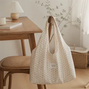Elegant cream tote bag with star patterns shown in a cozy interior lifestyle setting