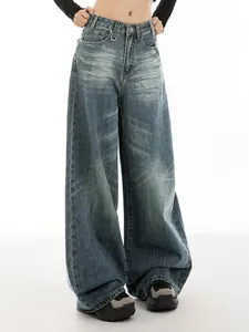 Close-up view of vintage washed blue wide-leg denim jeans with straight-cut design for women