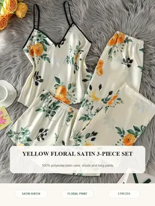 Detailed view of yellow floral print satin pajama set including camisole and pants