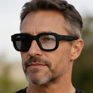 Close-up of retro black square frame sunglasses on male model featuring photochromic lenses