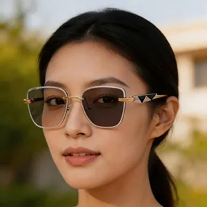 Close-up portrait of model wearing vintage metal frame square sunglasses with gold details