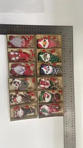 Detailed view of 12 wooden Christmas gnome ornaments measured with rulers for scale.