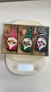 Detailed macro view of a 3-piece set of wooden Christmas gnomes in a rustic wooden gift box