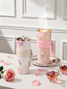 Detailed macro shot of floral insulated tumblers showcasing hot coffee and ice cube cooling