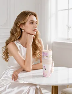 Detailed view of the elegant floral insulated coffee tumbler with straw on a table