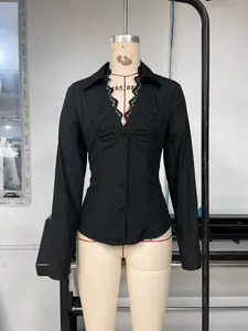 Detail view of black V-neck long sleeve shirt with lace trim on a mannequin