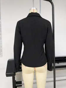 Detailed back view of a slim fit black long-sleeve shirt displayed on a mannequin