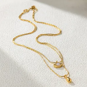 Close-up of double-layer gold titanium steel necklace with Angel Eye and teardrop pendants
