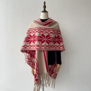 Detailed view of ethnic folk style shawl poncho featuring red snowflake pattern and tassels