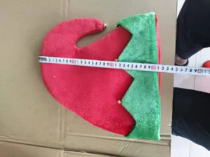 Detail showing the 35cm width measurement of the red and green plush Christmas elf hat.