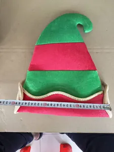 Detail shot showing the 30cm width of a striped red and green Christmas elf hat