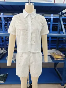 Detailed view of white eyelet lace two-piece shirt and shorts set on a mannequin