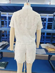 Rear view of white eyelet lace two-piece summer set with hollow-out floral design.