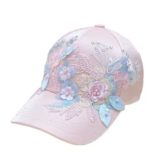 Elegant pink satin baseball cap featuring 3D floral embroidery applique and pearl accents