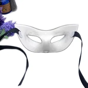 Close-up of a silver-white masquerade half-face mask with black silk ribbons for party.