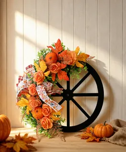 Autumn harvest wreath with wooden wagon wheel, roses, and pumpkins in warm scene display