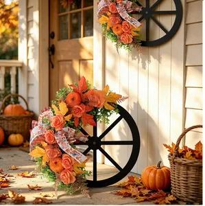 Detail view of a rustic wooden wagon wheel wreath with fall pumpkins and roses.