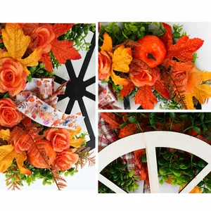 Close-up of autumn wreath details featuring pumpkins, maple leaves, and a wooden wheel