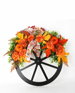 Decorative autumn Thanksgiving wreath featuring a wooden wheel with pumpkins and roses