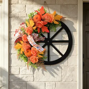 Rustic wooden wagon wheel wreath with pumpkins and roses for autumn harvest decor
