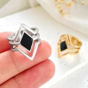 Macro view of retro multi-layer geometric ring featuring a black enamel diamond.