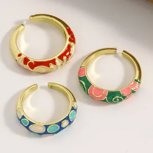 Detailed view of three vintage enamel alloy rings in red, green, and blue colors.