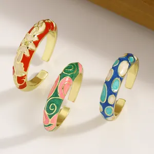 Detail showing three colorful enamel open rings with unique vintage geometric patterns