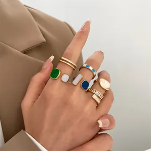 Detailed view of colorful enamel geometric rings on hand with vintage fashion design