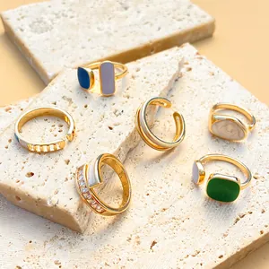 Detailed close-up view of vintage geometric drip oil rings in gold finish on stone slabs