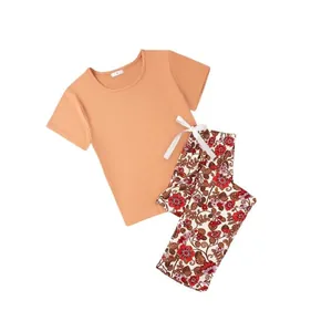 Casual women's summer pajama set with peach short sleeve T-shirt and floral long pants