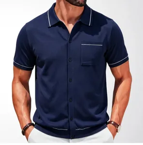 Close-up of navy blue knit polo cardigan with white piping and chest pocket details.
