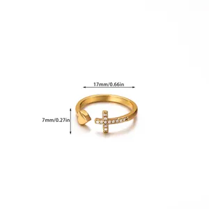 Detailed view of adjustable gold ring with cross and heart motifs showing 17mm diameter size