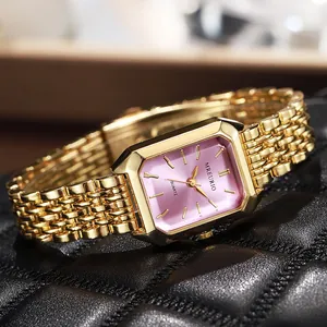 Macro view of a luxury gold square ladies watch with a radiant pink gradient dial