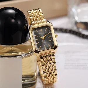 Close-up of gold square women's watch with elegant metal linked strap and black dial