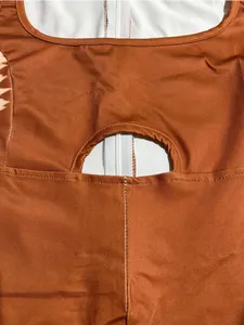 Close-up of back cutout and zipper detail on orange fashion jumpsuit for women.