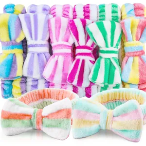 Close-up detail of colorful soft coral fleece striped bow headbands for SPA and skincare