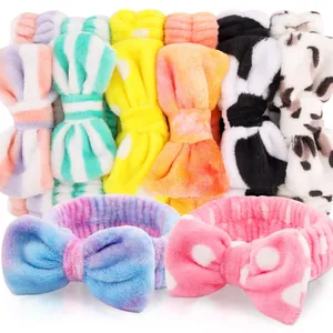 Collection of colorful plush coral fleece spa headbands featuring oversized bow designs