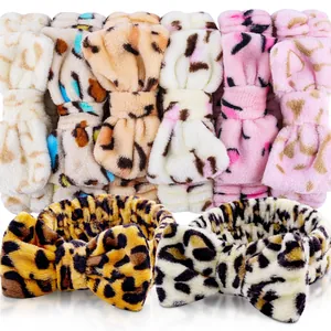 Macro detail of various leopard print coral fleece headbands with soft decorative bows