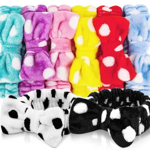 Detailed view of soft coral fleece bow headbands in multiple vibrant polka dot colors