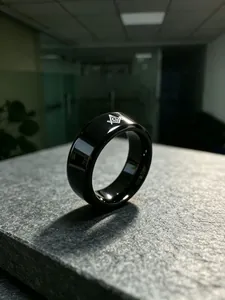 Close-up of black polished titanium steel ring with white Masonic symbol engraving