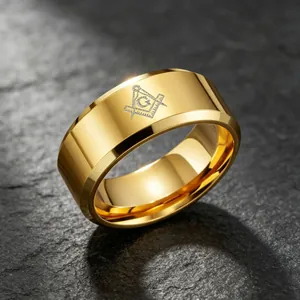 Close-up detail of a polished gold titanium steel ring featuring an engraved Masonic symbol.