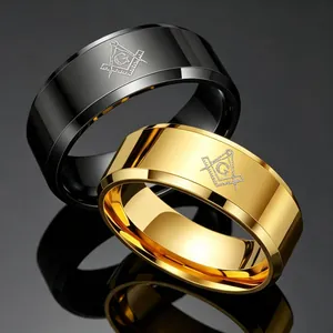 Men's titanium steel Freemason rings in gold and black finishes on a dark surface