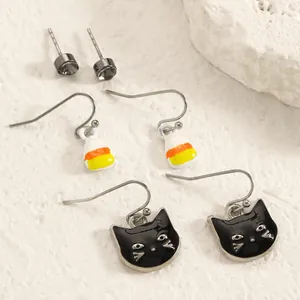 Detailed view of Halloween earring set featuring black cat and candy corn charms