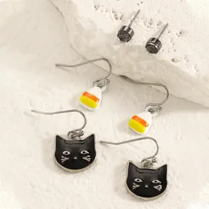 Detail view of Halloween earring set featuring black cats, candy corn, and studs