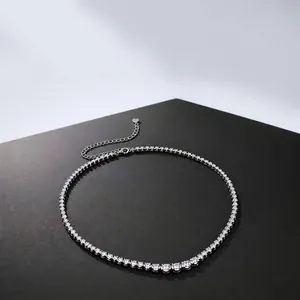 Close-up of s925 silver moissanite tennis necklace on a dark display surface